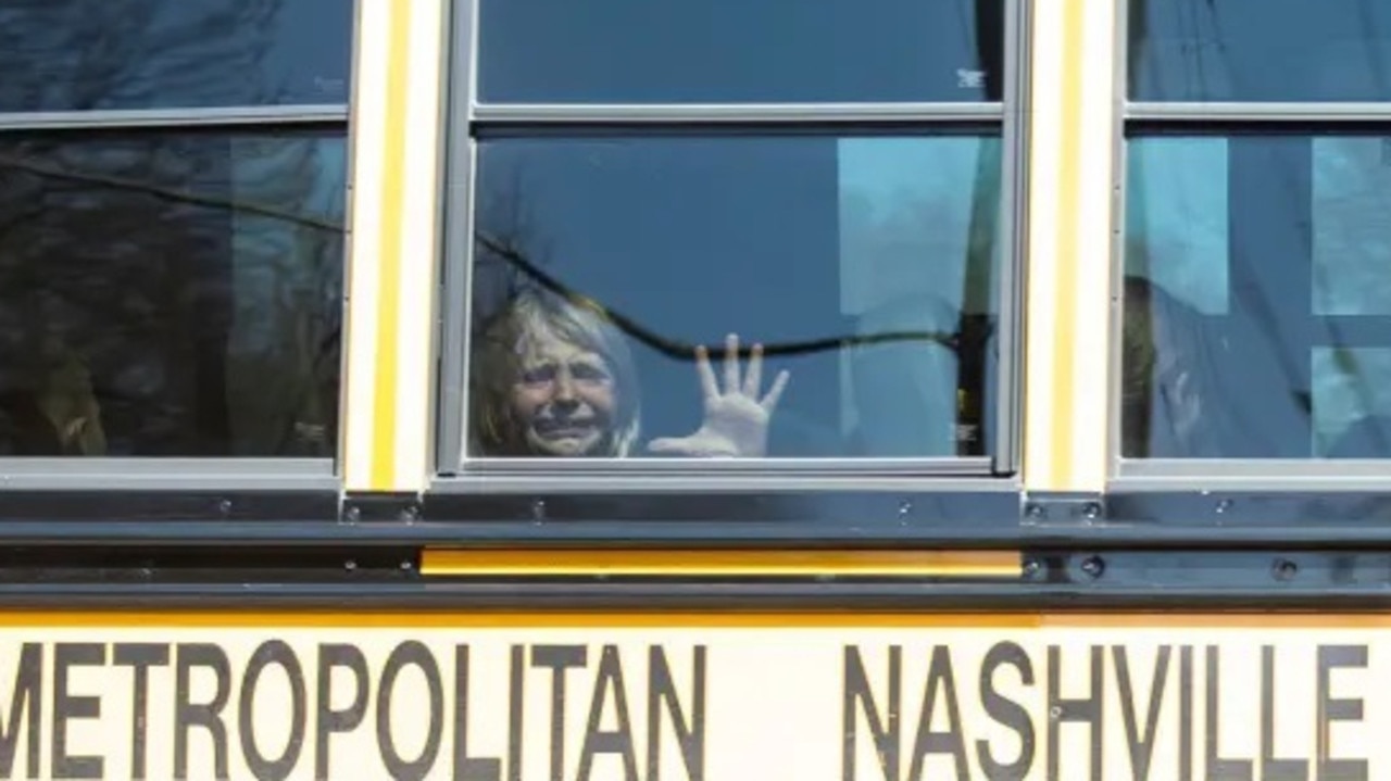 A terrified young student holds her hand against the window of a school bus in the aftermath of the shooting. Picture: Nicole Hester/USA TODAY NETWORK/Sipa USA /AAP Image