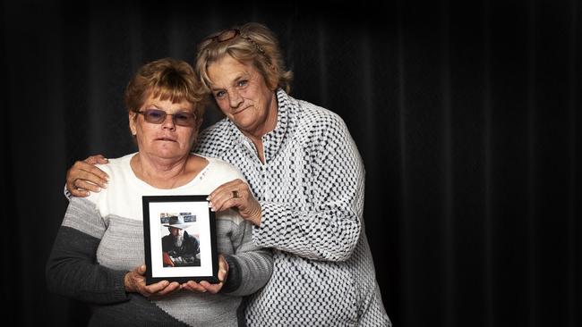 Sisters Shirley Strochnetter, left, and Tammy Williams hold a picture of their brother John Norrish, who went missing in November 2018, from St Helens. Picture: CHRIS KIDD