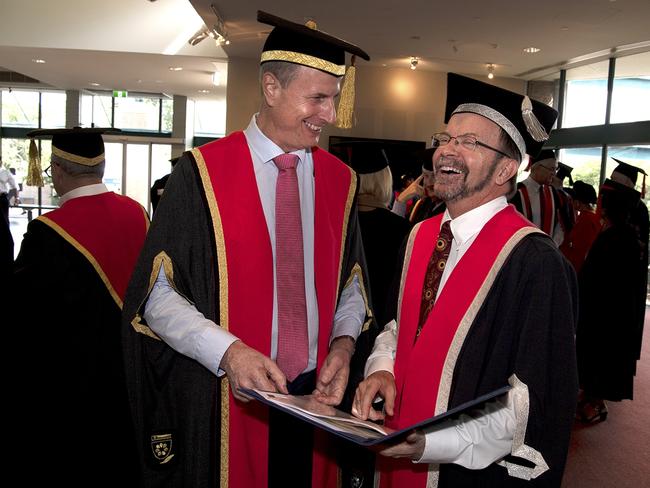 The newly installed Chancellor of Charles Darwin University, the Hon Paul Henderson AO (left), shares a happy moment with CDU’s Vice-Chancellor Professor Simon Maddocks at yesterday’s Investiture ceremony on Casuarina campus.SUPPLIED