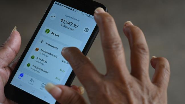 Using the bitcoin app in El Salvador. Picture: AFP