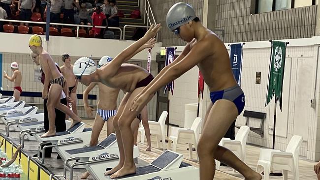 A Churchie swimmer prepares for a relay change.