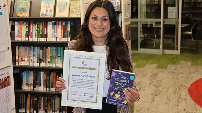 Samera Kamaleddine with her latest book and the acknowledgment from the Bayside Council. Picture: Lorraine Olmedo