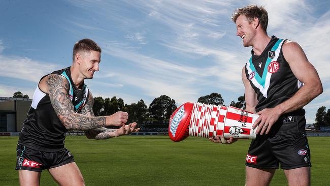 Hamish Hartlett and Tom Jonas enjoy Port Adelaide’s new sponsor KFC. Picture: Sarah Reed