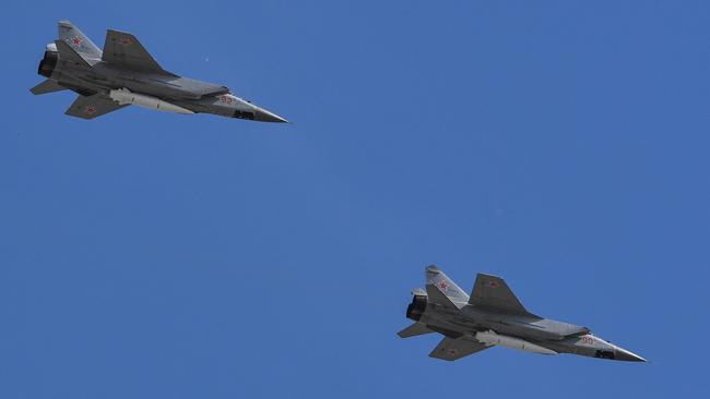 This file photo taken in May 2018 shows Russia's MiG-31 supersonic interceptor jets carrying hypersonic Kinzhal (Dagger) missiles flying over Red Square. Picture: AFP