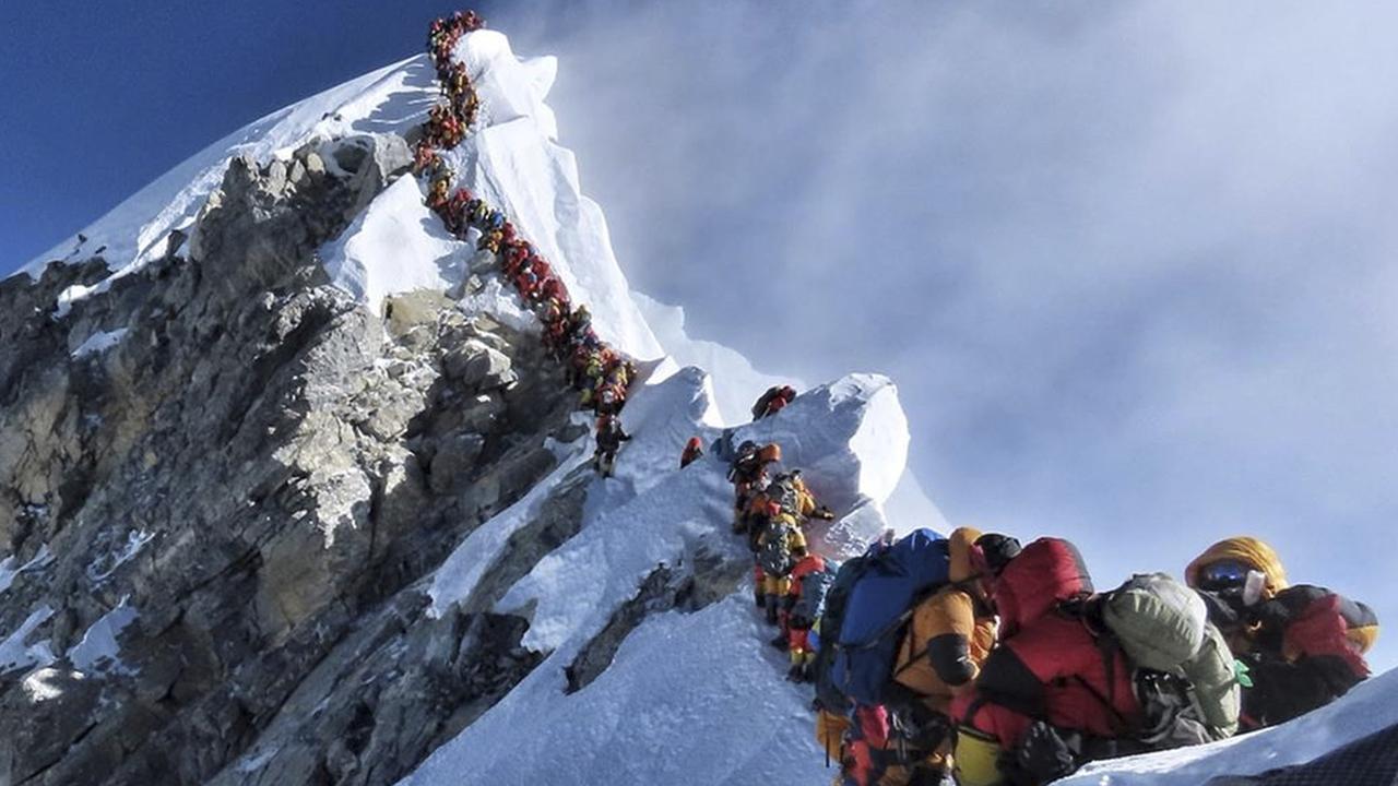 A long queue of mountain climbers line a path on Mount Everest desperate to reach the top. Picture: Nimsdai Project Possible via AP.