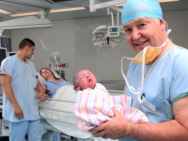 Newborn Alaska Rose Love with Professor Michael who delivered her, with proud parents Madeleine Love and Korey Turk in the background. Picture: Peter Kelly