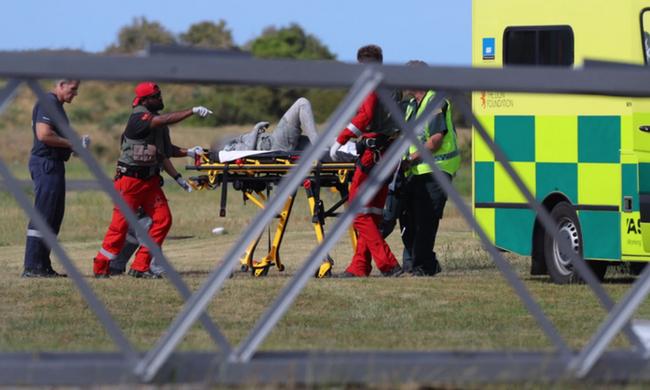 A person covered in ash arrives at Whakatane Airfield. Picture: Alan Gibson