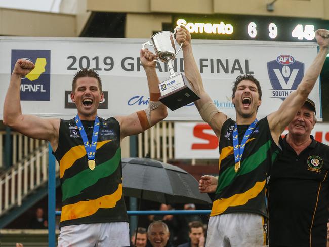 Dromana coach Rikki Johnston and captain Terry Wheeler lift the MPNFL Division 1 premiership cup. Picture: Valeriu Campan