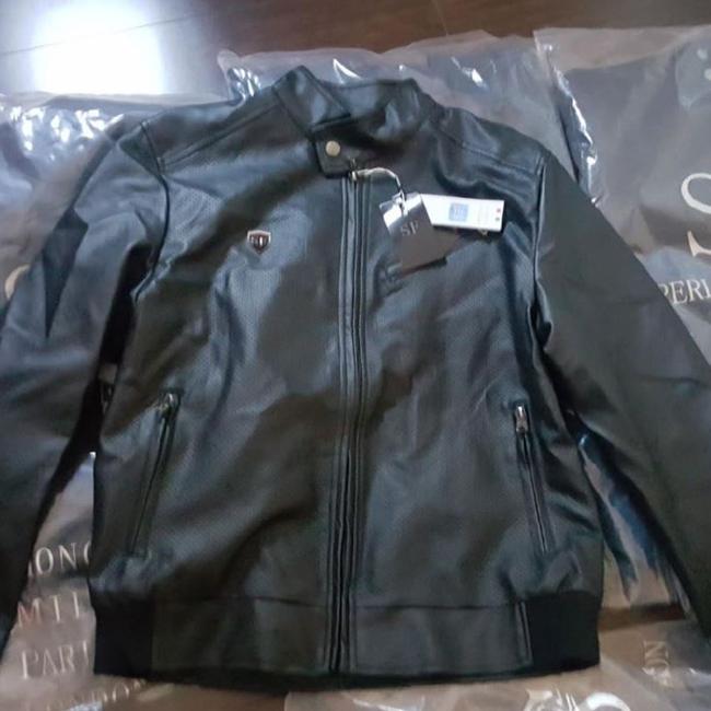 Police seized a further 22 fake jackets, cash and business cards from his Five Dock apartment.