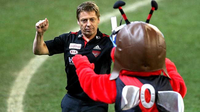 Mark Thompson celebrates Essendon’s win with the club mascot. Picture: Wayne Ludbey