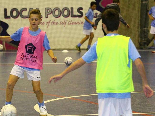 JSS star for this week Jake Miller, 12, and kids at the indoor soccer academy. Also pics of Andre Thomasian with Jake Miller. Both represented Australia in Under 13's Futsal. Pics Ian Svegovic