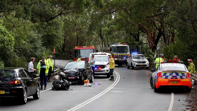 Emergency services at the scenes of a head-on collision between a car and motorbike on Wakehurst Parkway at Narrabeen on Thursday morning. Picture: Toby Zerna