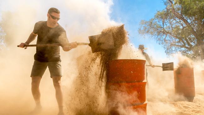 The dusty sand shovelling competition at the Henley on Todd Regatta. Alice Springs August 19 2017. Photo: EMMA MURRAY