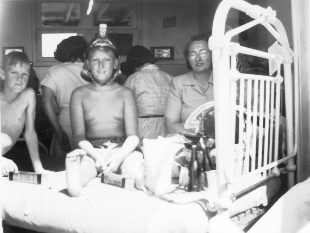 Norm Appleby at the Children's Hospital Orthopaedic Section in Mt Eliza while recovering from polio in 1949-50, pictured during a Christmas visit from the Melbourne Fire Bridgade.