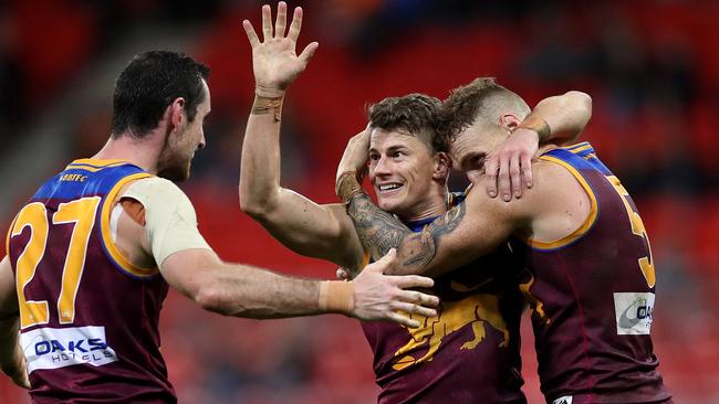 Brisbane stalwarts Dayne Zorko, Darcy Gardiner and Mitch Robinson celebrate the win. Picture: Phil Hillyard