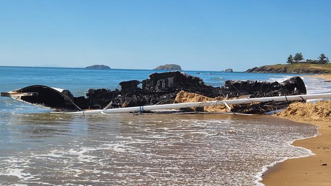 The burnt remains of the 15.2m yacht, Scoundrel, on Main Beach, Emu Park, on November 25, 2022. Photo: Darryn Nufer.