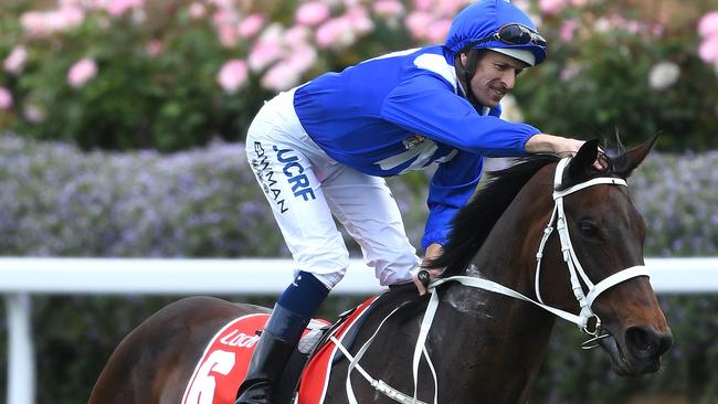 Hugh Bowman gives Winx a pat after her fourth Cox Plate triumph. Picture: AAP