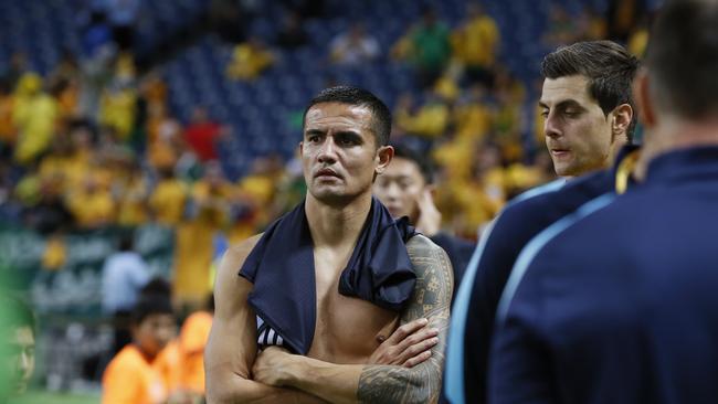 Australia's Tim Cahill looks at Japan's team celebrated their win after their World Cup Group B qualifying soccer match in Saitama, Japan, Thursday, Aug. 31, 2017. (AP Photo/Shuji Kajiayma)