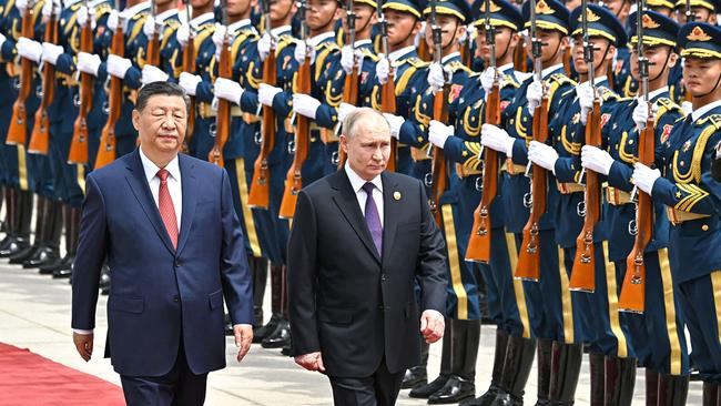 Vladimir Putin and Xi Jinping review a military honour guard in Beijing on Thursday. Picture: AFP