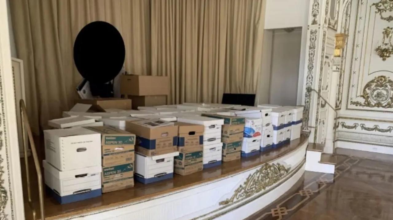 The now-seized documents seen on a stage at a ballroom at Mar-a-Lago. Picture: Department of Justice