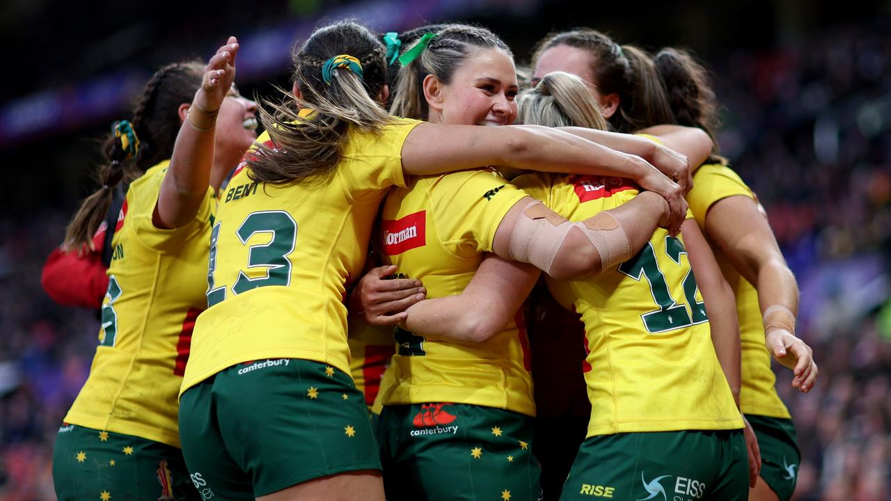 Evania Pelite celebrates with teammates after another Australian try. Picture: Getty Images