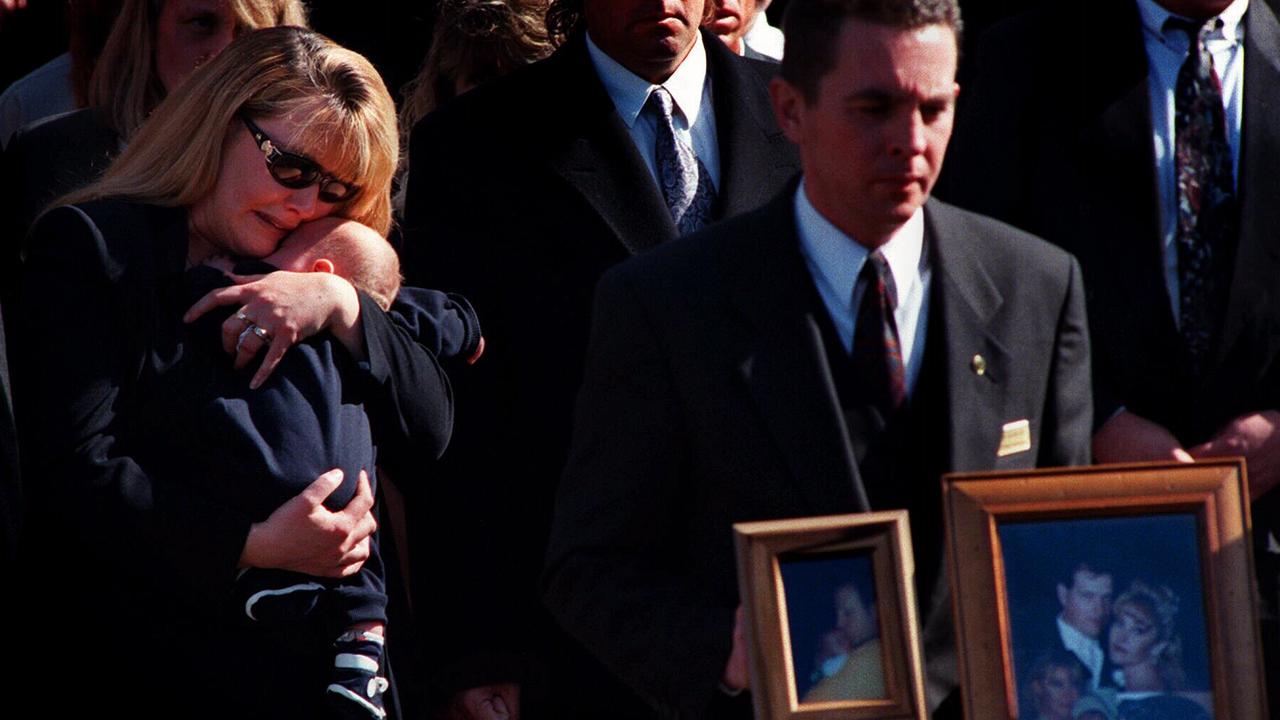 Senior Constable Miller’s wife, Carmel Miller, at his funeral holding their seven-week-old son.