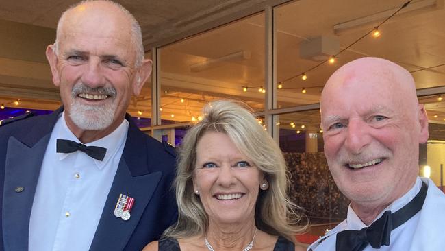 John Herlihy, Janett Calland and Colin Boucher celebrate at the Gympie RSL Masked Ball, April 29 2023.