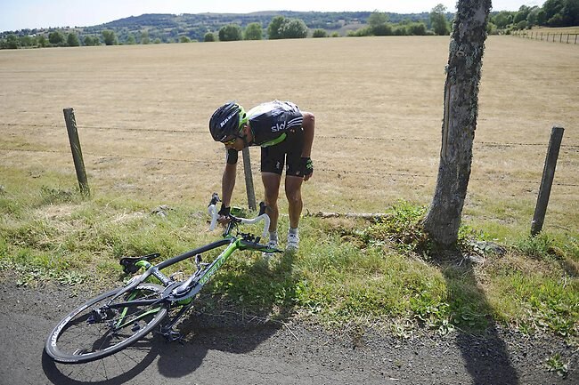 <p>Juan Antonio Flecha picks up his broken bike after a French TV car knocked him off it on stage nine of the Tour de France</p>