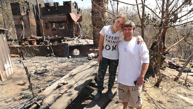 Wytaliba fireman Jesse Kirkman 34 and his daughter Isabella 13, with their burnt out house. Picture: Lyndon Mechielsen