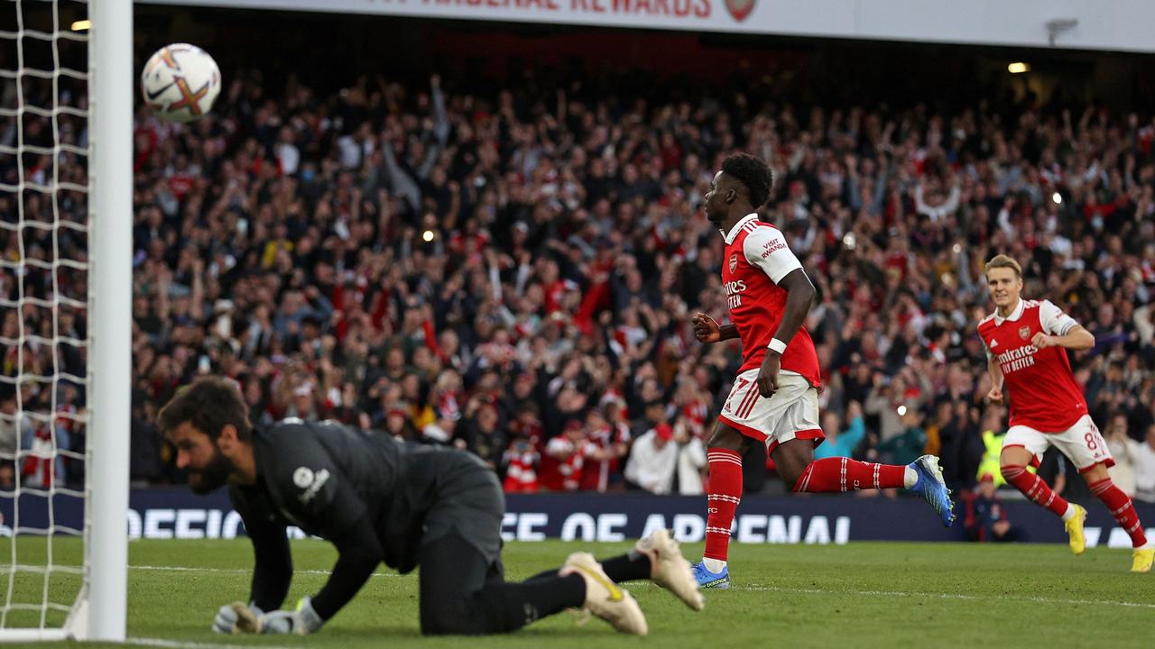 Arsenal's English midfielder Bukayo Saka (C) celebrates scoring the team's third goal from the penalty spot during the English Premier League football match between Arsenal and Liverpool at the Emirates Stadium in London on October 9, 2022.