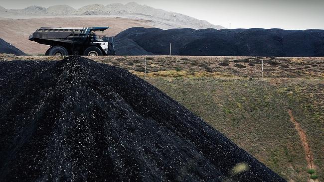 A coal truck passes a huge pile of coal at BHP’s Mt Arthur coal mine in Muswellbrook, Upper Hunter. Picture: Getty Images