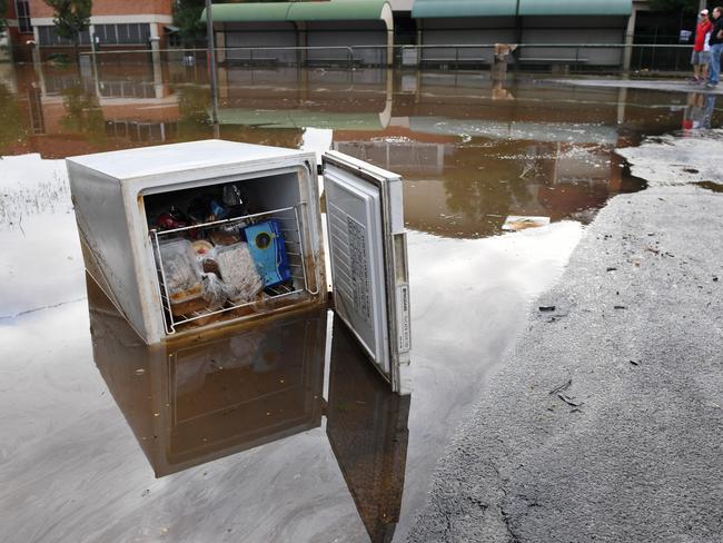 A freezer full of food is left on the side of the road as floodwaters recede in Lismore on Saturday. Picture: Tracey Nearmy / AAP