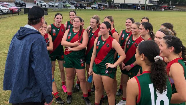 The Sandgate girls listen to an address from their coach Shane Watterson.