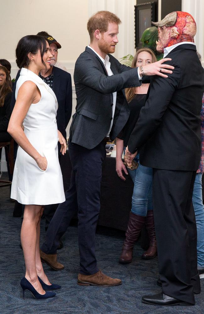 Luke Hawker, dressed as an orc, meets the Duke and Duchess of Sussex during a visit to Courtenay Creative in Wellington. Picture: AAP