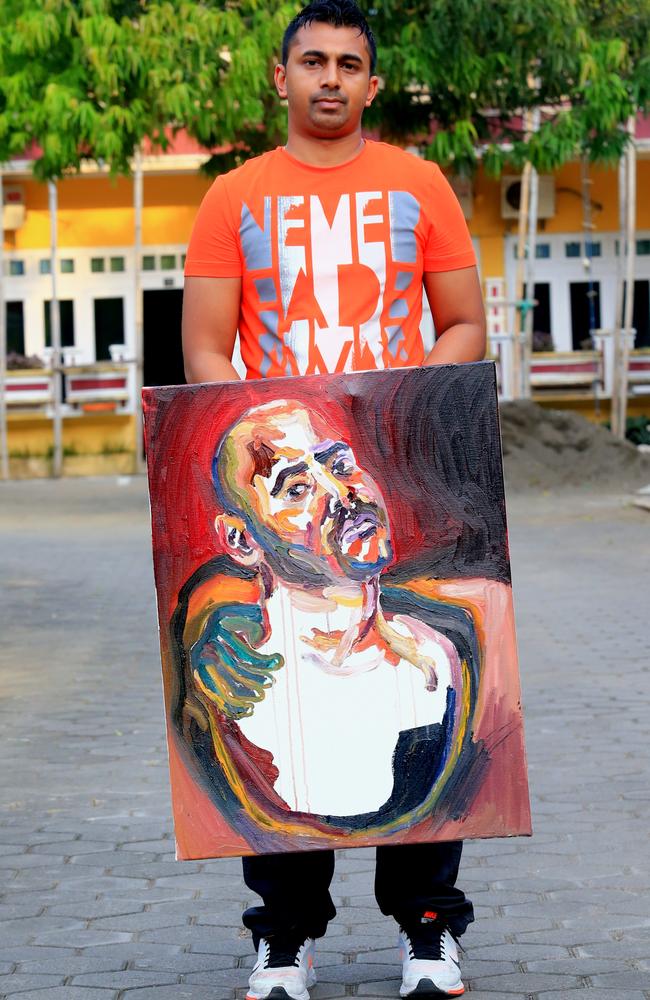 Chinthu Sukumaran holds up a final portrait by his brother Myuran after their last visit before the execution. Picture: Adam Taylor.