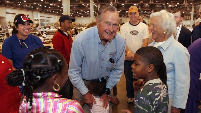 Former President George Bush and his wife Barbara visit with hurricane Katrina evacuees in the Reliant Center adjacent to the Astrodome in Houston in 2005. Picture: Richard Carson/POOL