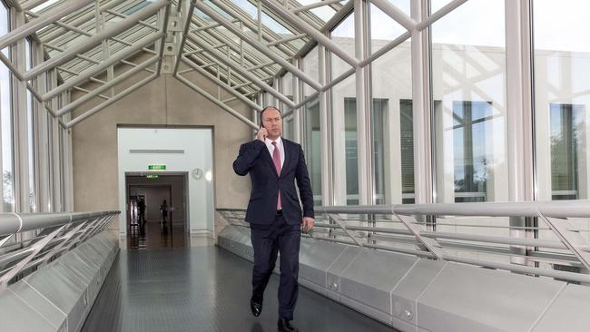 Treasurer Josh Frydenberg walks the empty corridors of Parliament House in Canberra. Picture: Gary Ramage.