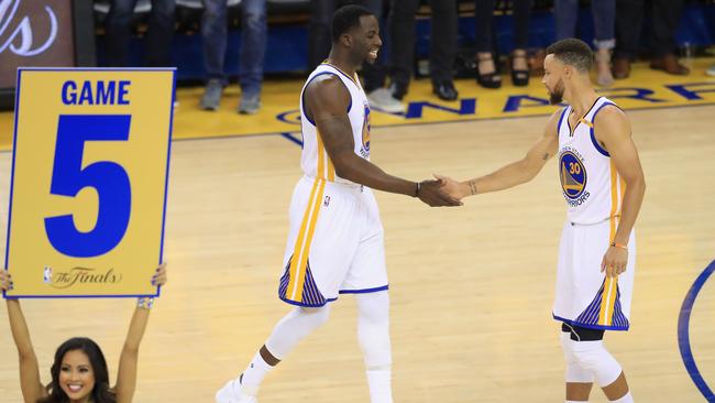 Draymond Green and Stephen Curry prepare for the opening tip-off. Picture: AFP