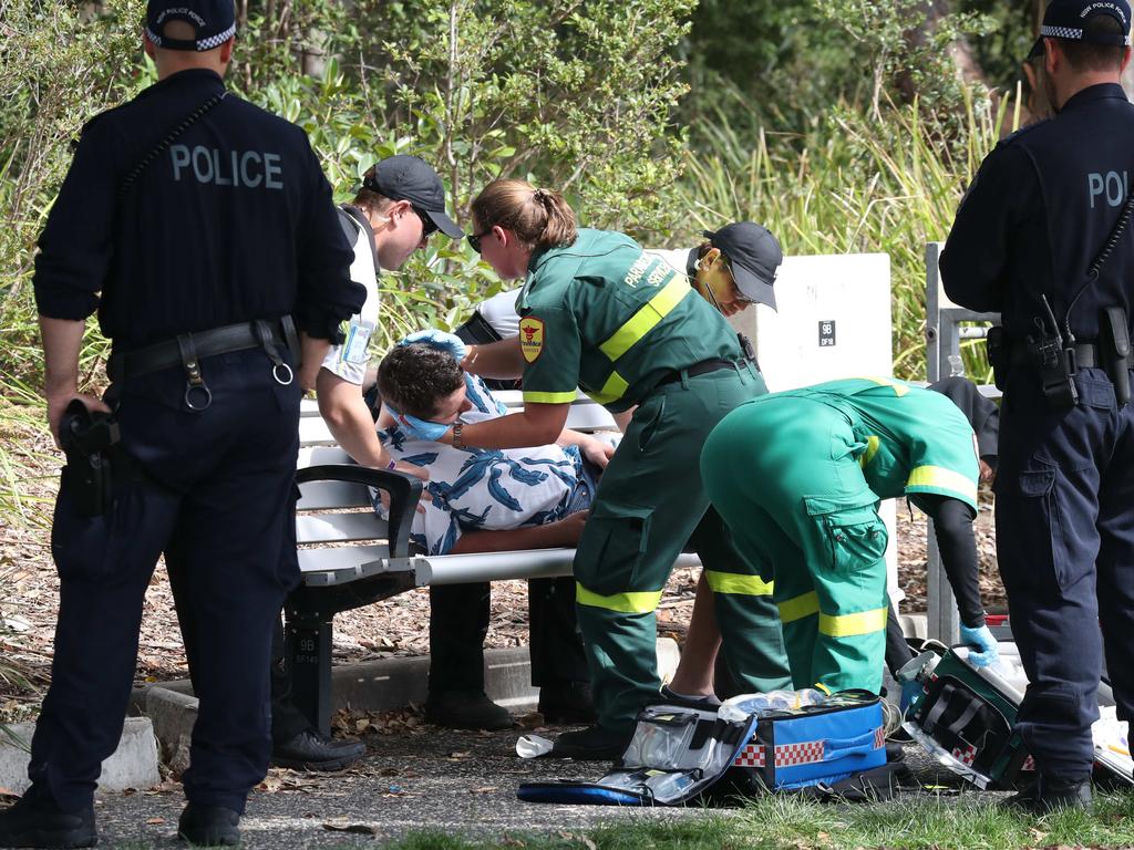 Paramedics help the passed-out man. He was eventually revived and taken away by paramedics.