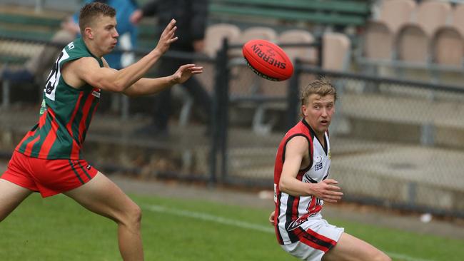 Lachlan Burrows for The Basin and Kieran Edwards for Knox compete for the ball. Picture: Stuart Milligan