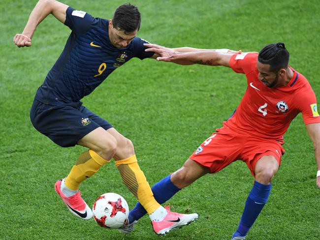 Tomi Juric tries to keep Mauricio Isla at bay.