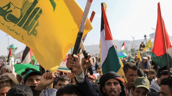 Yemenis lift Palestinian national flags and banners of Lebanon's Hezbollah movement during a rally held in the Houthi-controlled capital Sanaa in protest against Israel's attacks on Lebanon and Gaza. Picture: Abdallah Adel / AFP