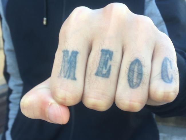 MUST GET LEGAL ADVICE BEFORE PUBLISHING THIS IMAGE. A NON PUBLICATION ORDER IS IN PLACE. A member of Brothers For Life exhibits his MEOC tattoo, which stands for Middle Eastern Organised Crime