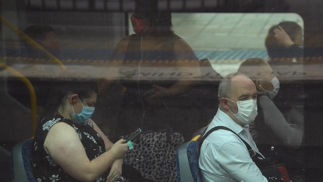 Passengers wear face masks on a train at Central Station in Sydney. Picture: Joel Carrett