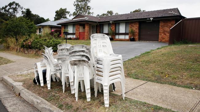 Rented chairs stacked outside the Air BnB house after they were dusted for finger prints. Picture: Richard Dobson