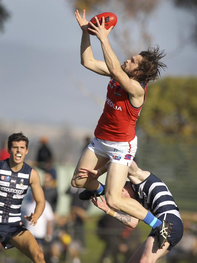 Norwood's Cameron Shenton takes a screamer over South's Mark Noble. Picture Dean Martin