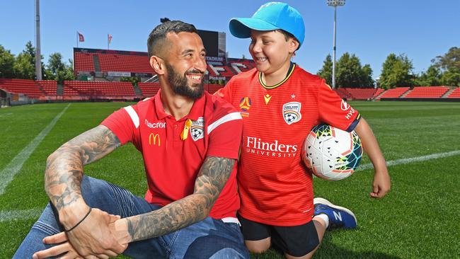 Adelaide United goalkeeper and Childhood Cancer Association ambassador Paul Izzo with seven-year-old Ace Kounavis. Picture: Tom Huntley