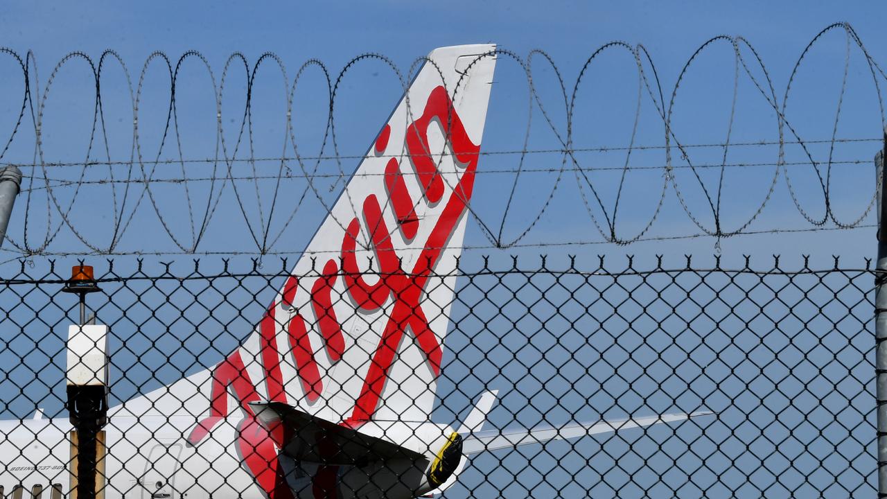 A grounded Virgin Australia aircraft parked at Brisbane Airport on Friday. Picture: AAP / Darren England