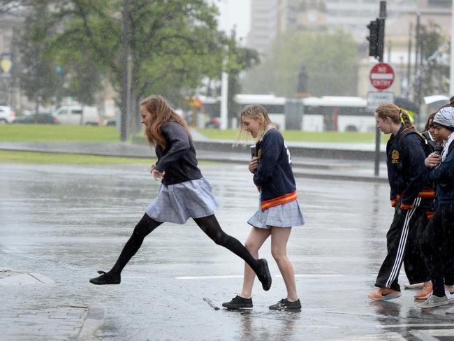 School students jumping puddles at Victoria Square, Adelaide. Picture Greg Higgs