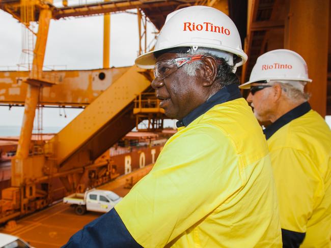 CAREERS: Gumatj Corporation deputy chairperson Djawa Yunupingu and chief executive Klaus Helms watch the first bauxite shipment to China from Gulkula, the first Indigenous-owned bauxite mine in Australia. Gulkula supplies directly to Rio Tinto. Picture: Supplied